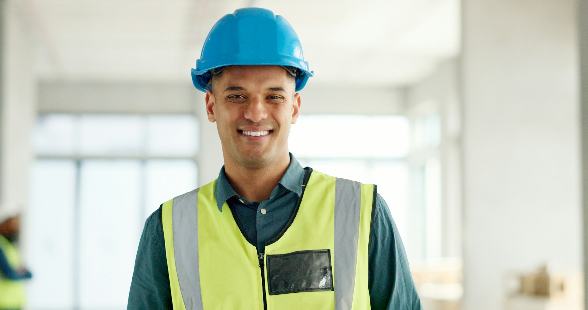 Construction, building and construction worker, man and smile in portrait, employee at construction