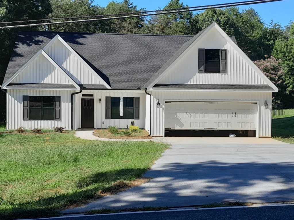 A homeowner's original photo of a white farmhouse-style house
